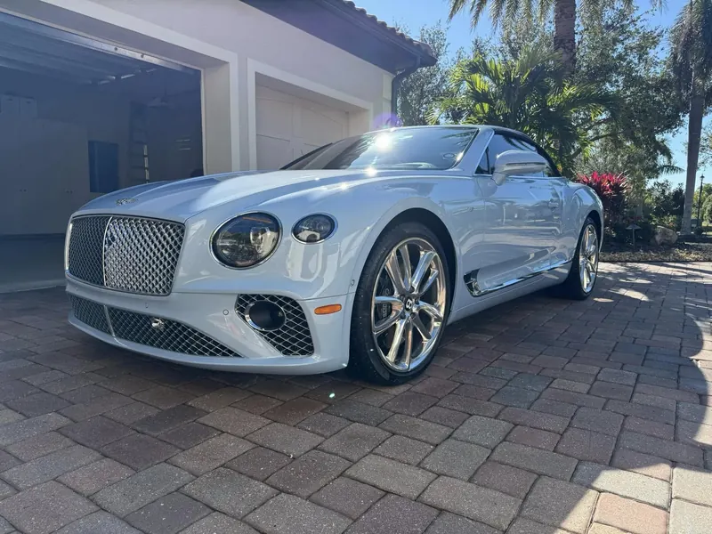 Freshly detailed white Bentley convertible in a driveway
